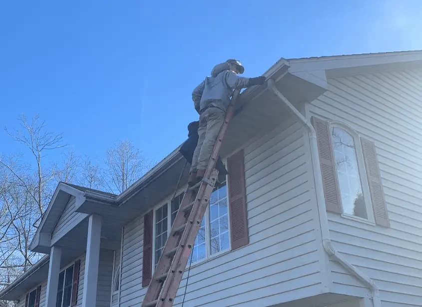 Gutter cleaning and maintenance being performed by Euclid Power Washing in Euclid